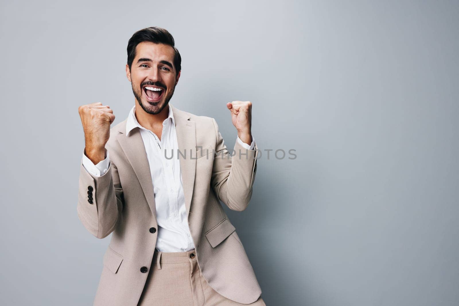 man victory businessman hand happy business winner arm beige suit job by SHOTPRIME