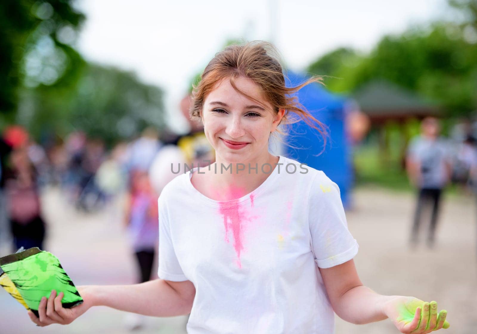 Pretty girls in indian traditional Holi festival with colorful powder having fun. Female teenager and preteen child enjoying positive holiday of India