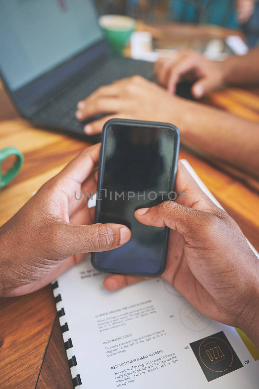 Updating our social media followers. two unrecognizable friends sitting together and using technology in a coffeeshop