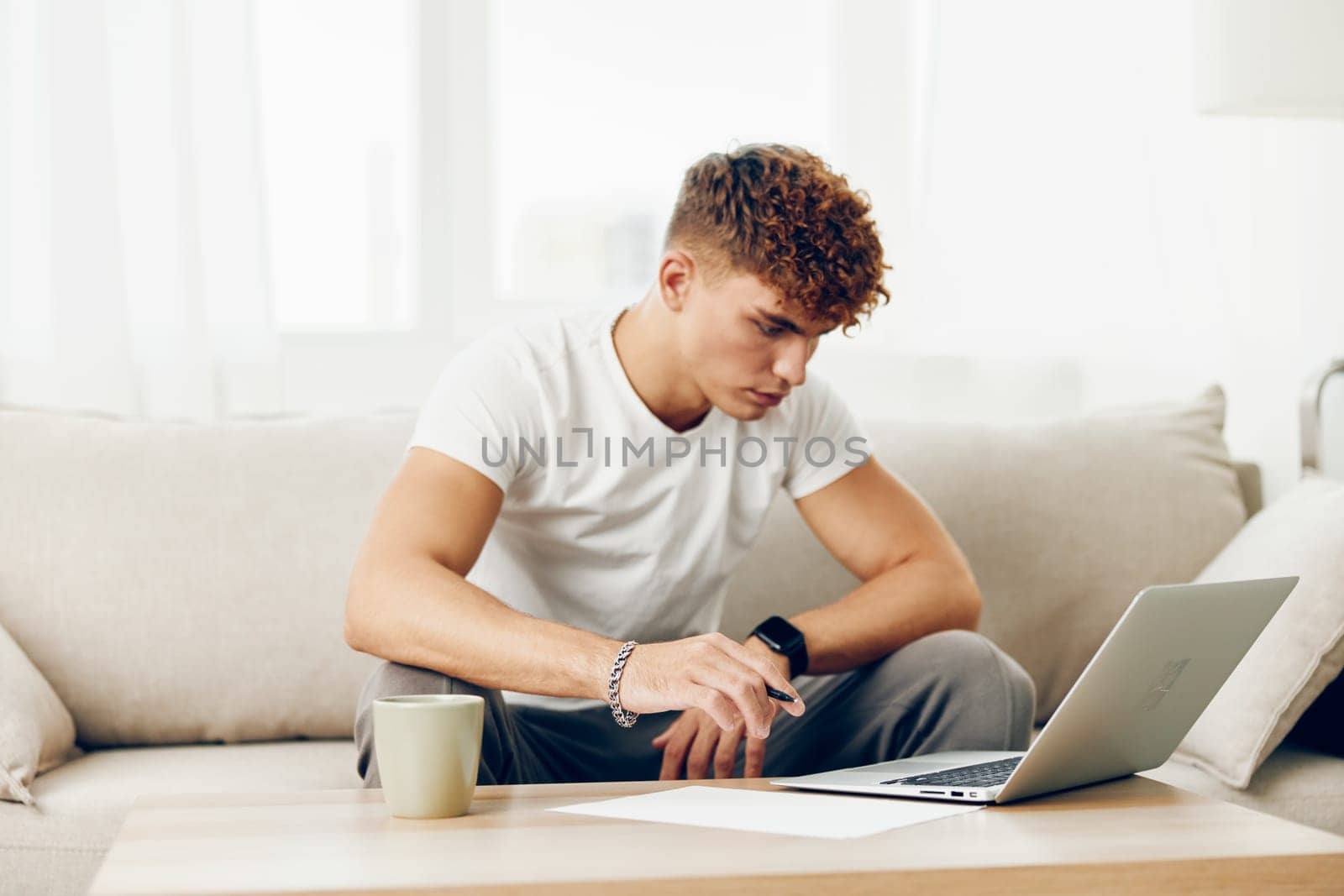 man computer phone browsing freelance lifestyle indoor blissful looking sitting education online using communication