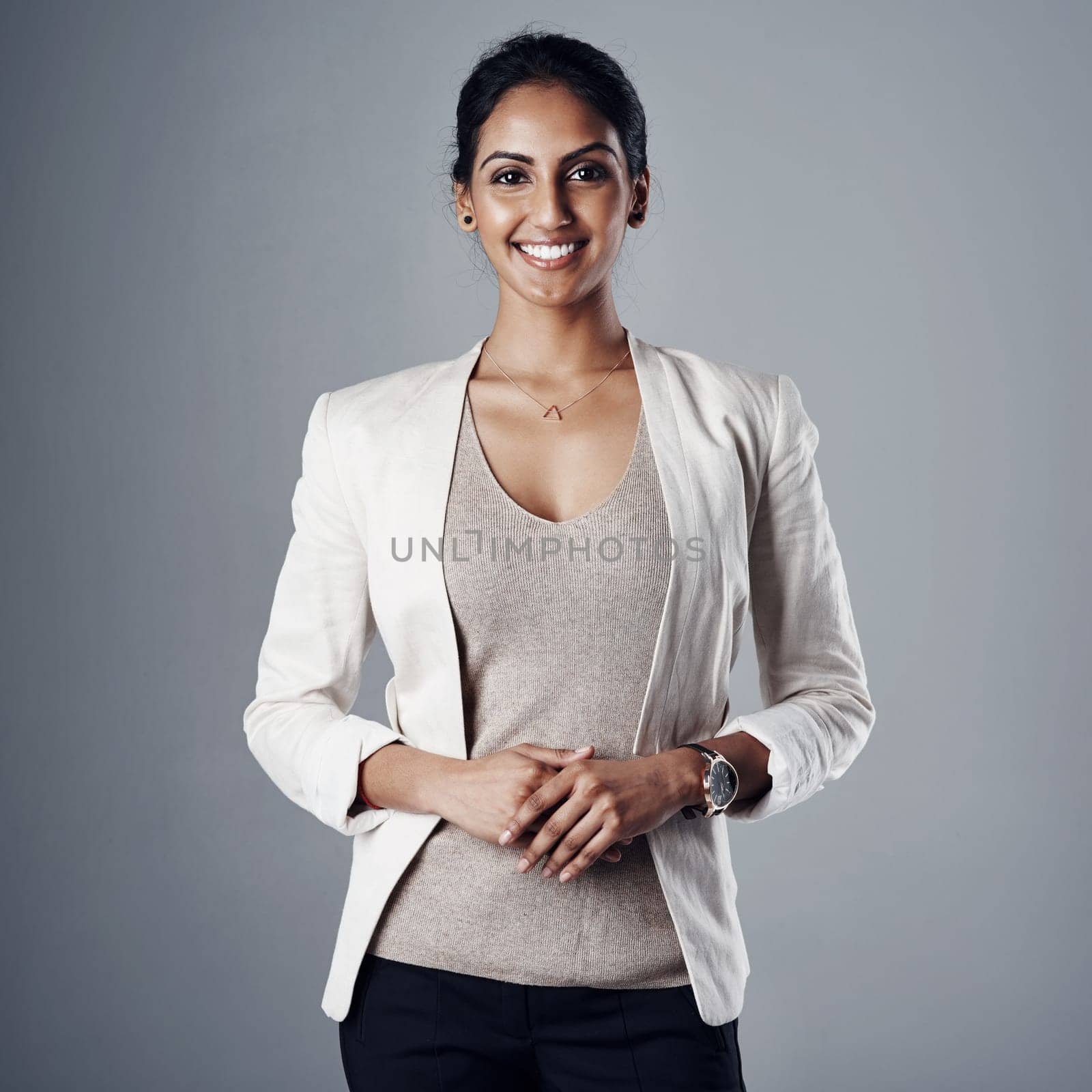 Self belief is key to having a successful career. Studio portrait of a young businesswoman posing against a gray background. by YuriArcurs