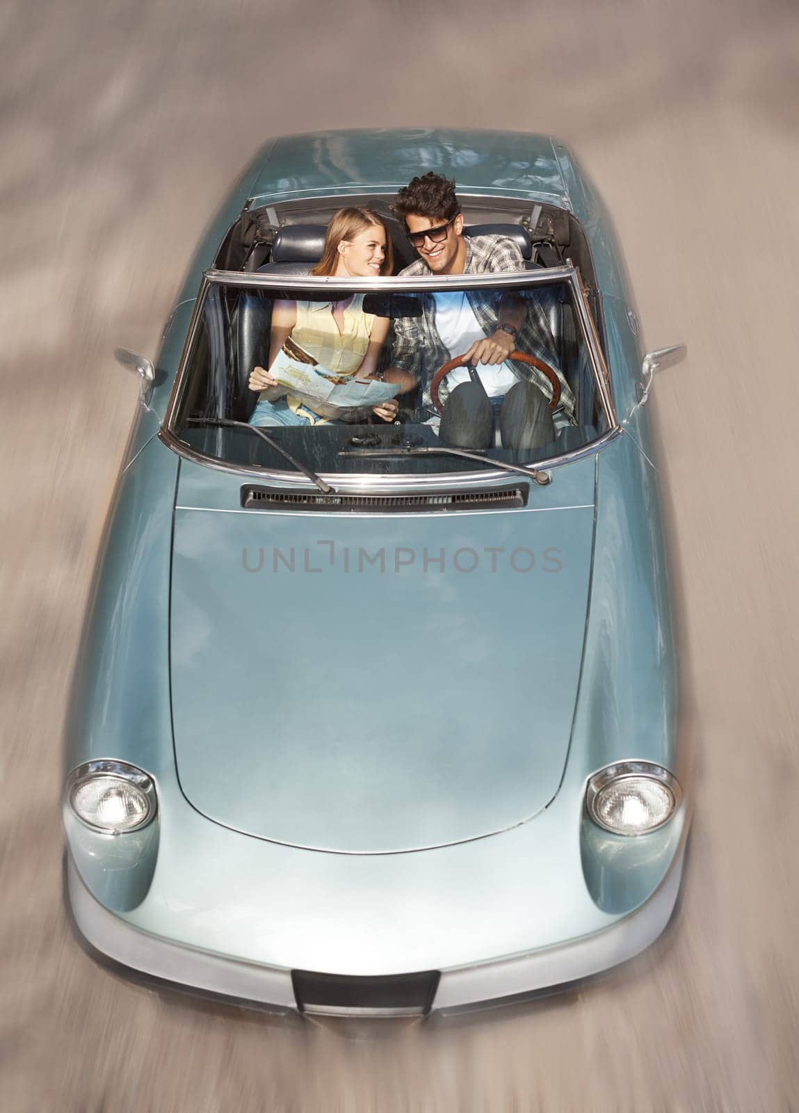 Couldnt ask for a better day. High angle view of a young couple enjoying a trip in their sports car