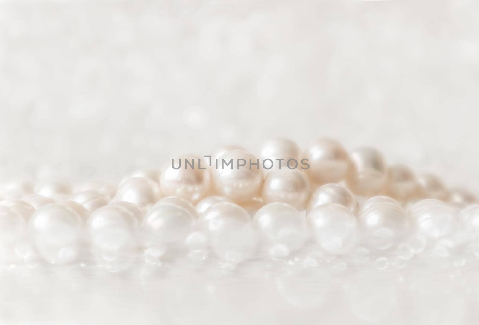 Nature white string of pearls on a sparkling background in soft focus, with highlights by Olayola