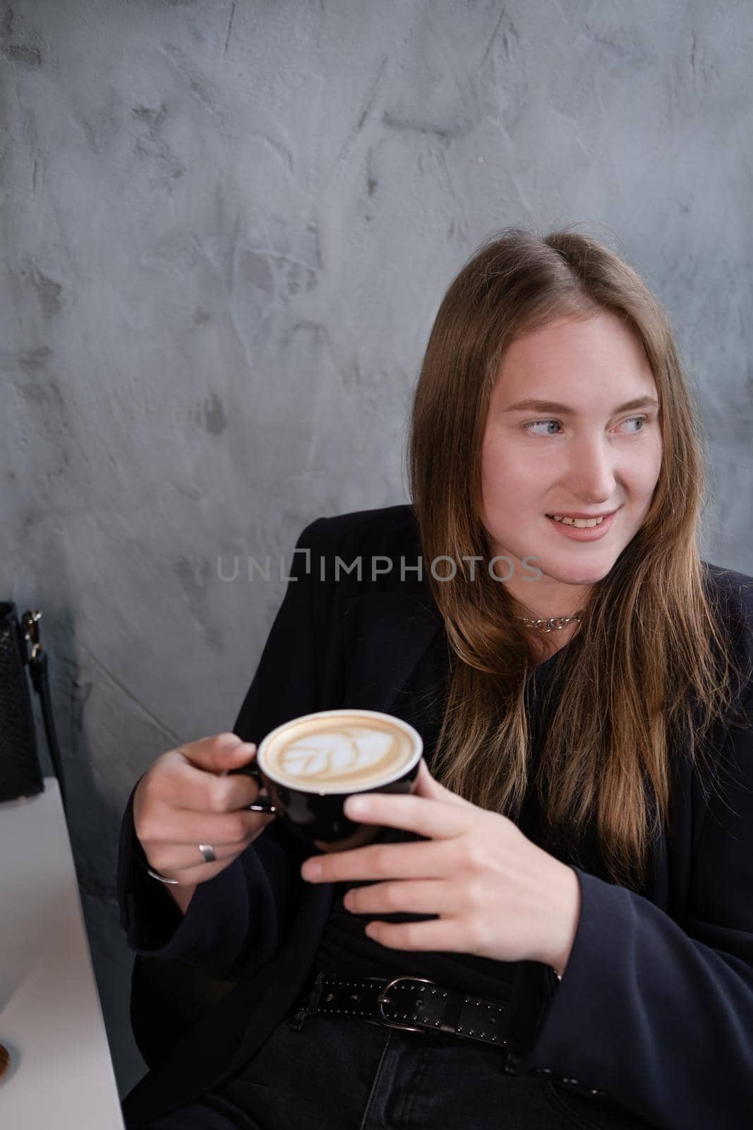 charming confident brunette woman in a cafe with coffee. coffee break. business woman.