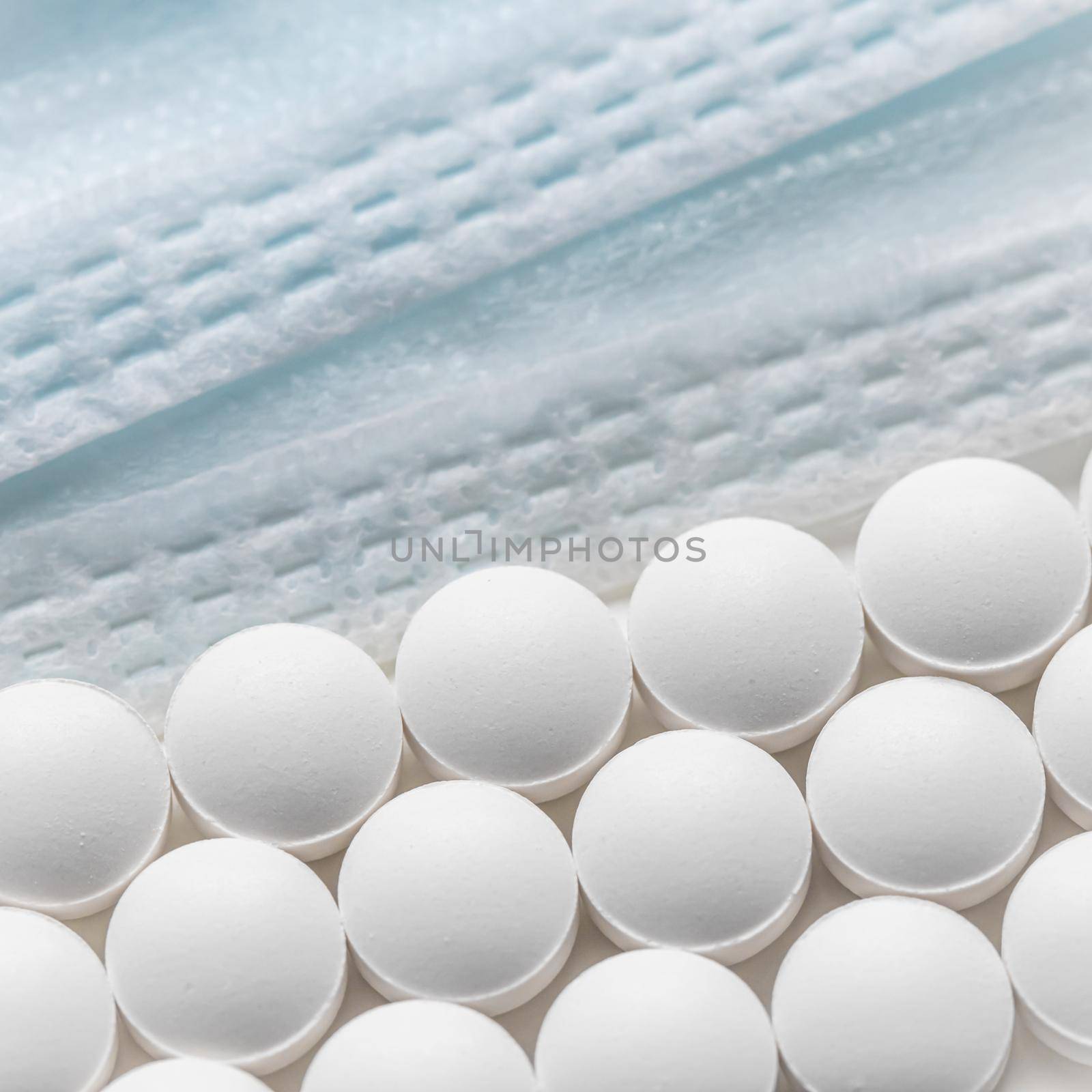 Rows of pills and medical masks on a white background. Health care, medicine, pharmacy and disease concept