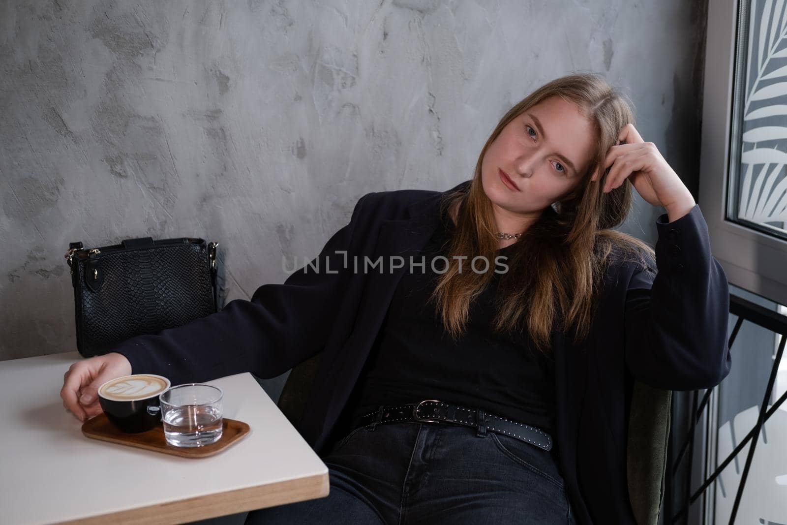 charming confident brunette woman in a cafe with coffee. coffee break. business woman.