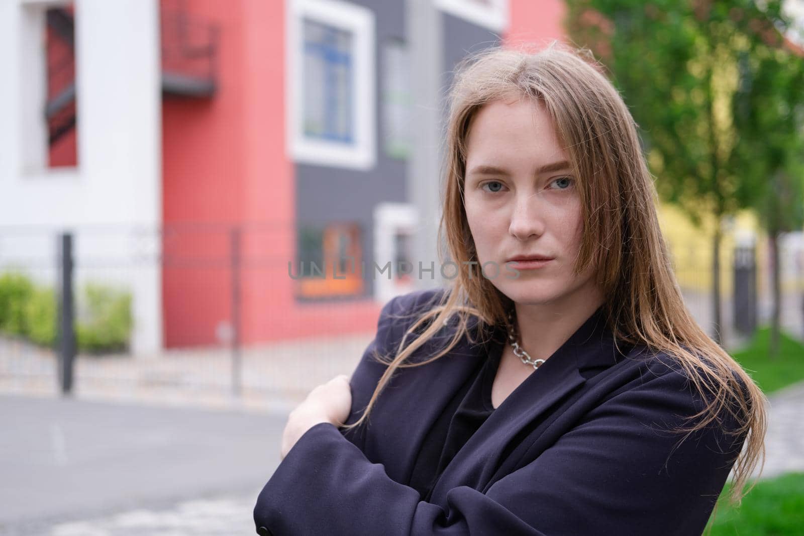 pretty brunette woman on background of bright modern buildings. feminine. millennial people. lady on walk.