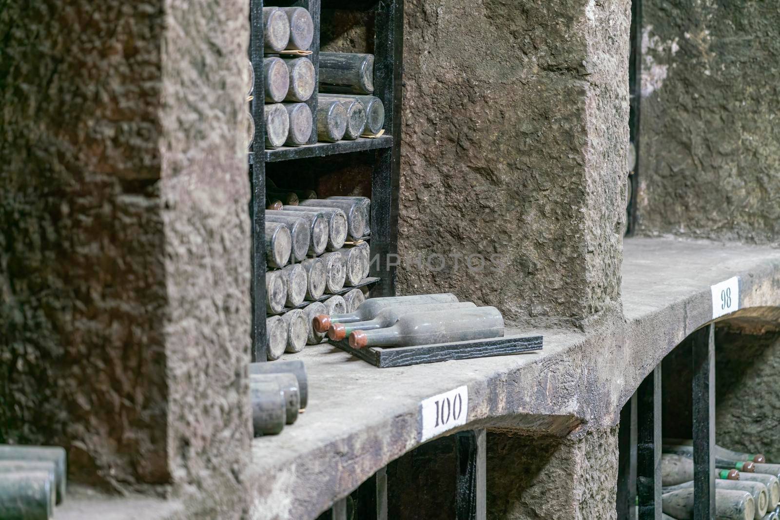 collections of old wine bottles in wine cellars by roman112007