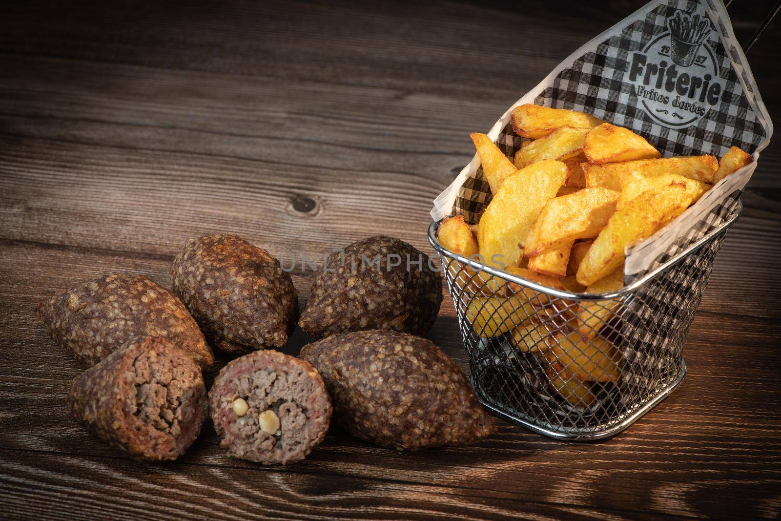 Traditional kebbe and pita bread on big round plate in lebanese restaurant. High quality photo