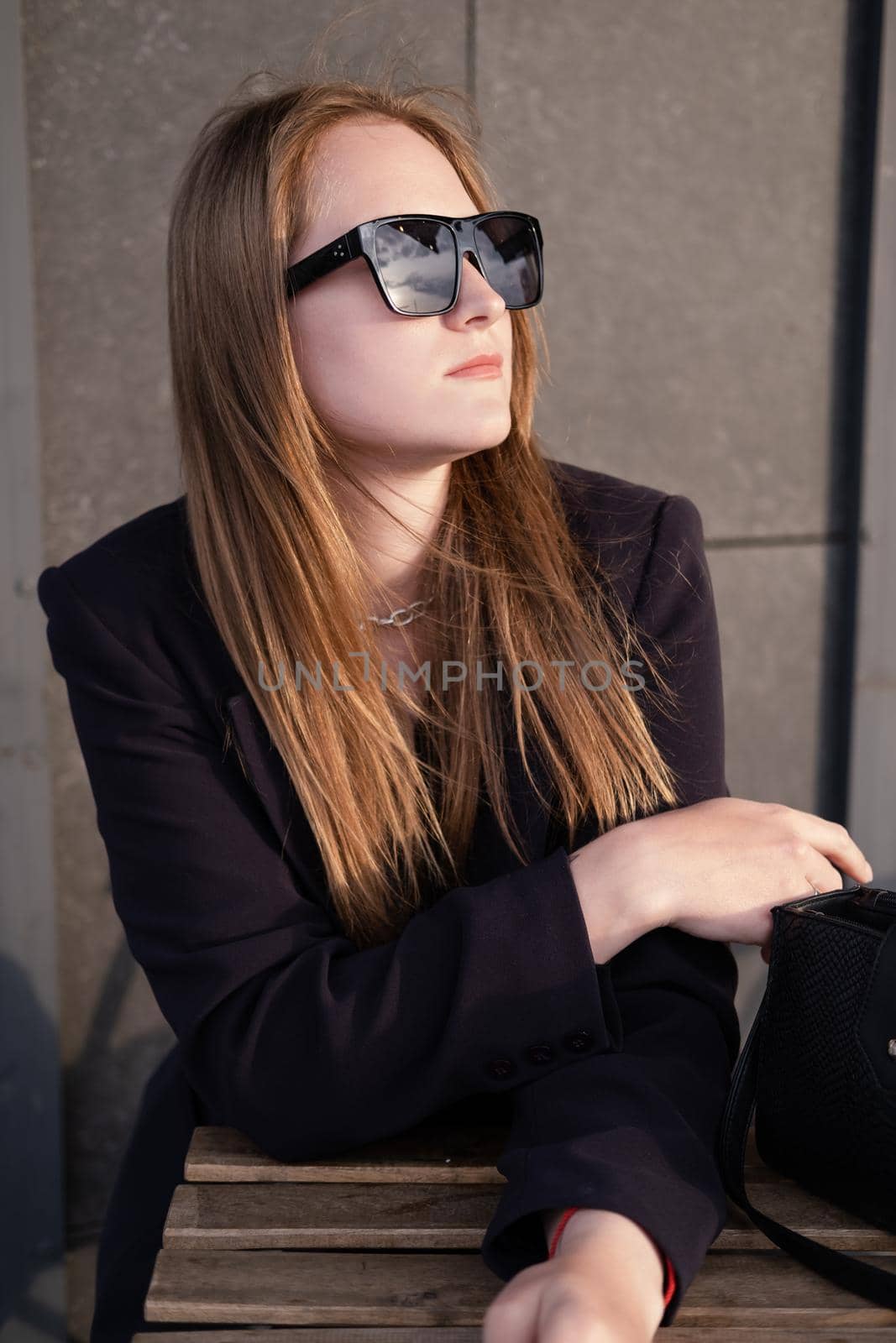 pretty brunette woman sitting by wooden table outside. feminine. millennial people. lady on coffee break.