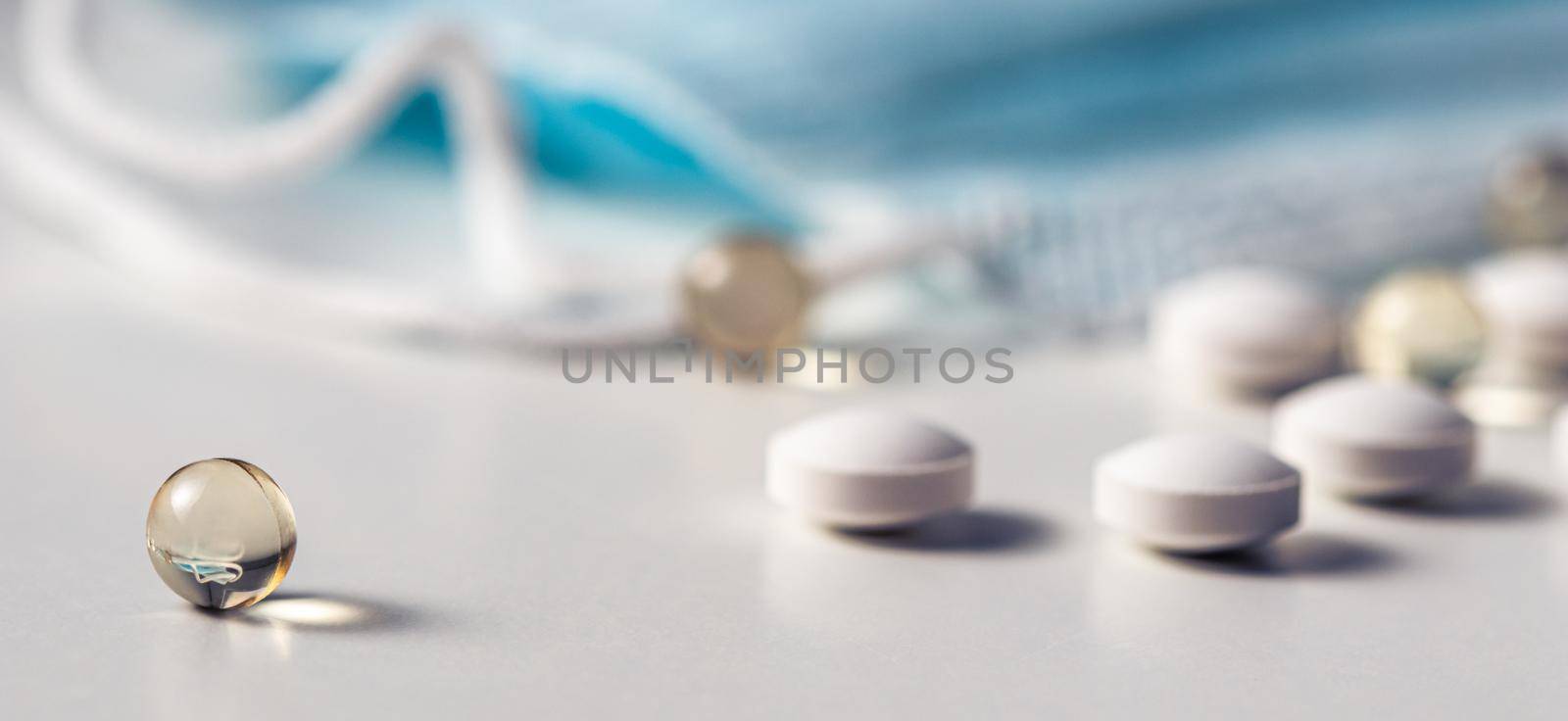 Capsules, pills and medical masks on a white background. Health care, medical, pharmacy and illness concept