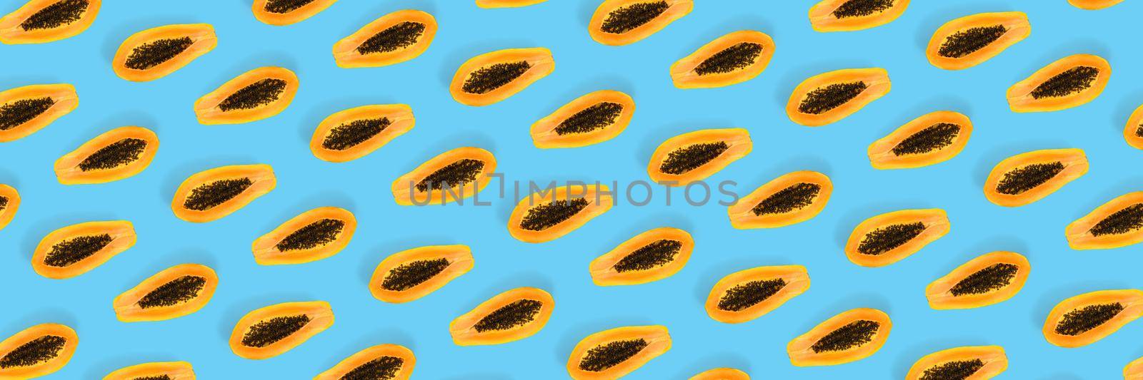 Fresh ripe papaya background on blue backdrop. Tropical abstract background. Top view. modern by PhotoTime