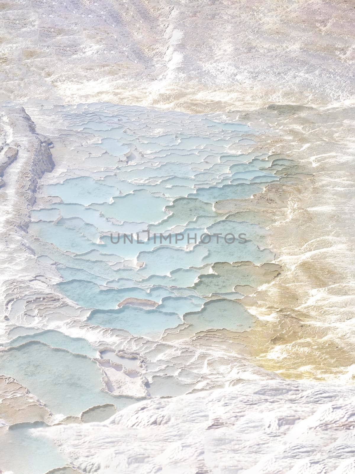 Texture with abstract pattern in pastel natural colors. Pamukkale calcium travertine in Turkey, top view.