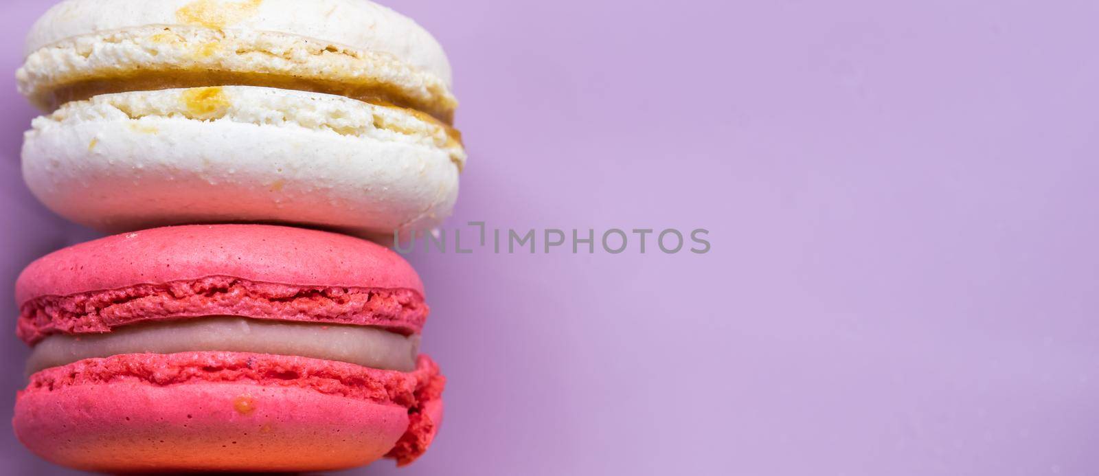 Colorful french cookies macarons set on pink background. Tasty fruit, almond sweet cookies, cake macaron by Olayola
