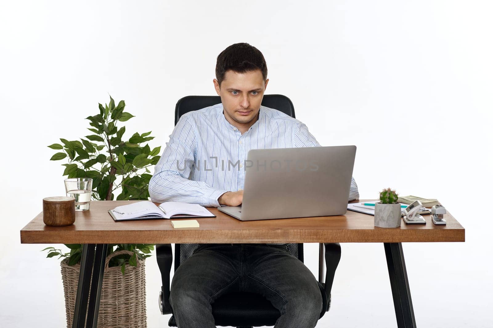 entrepreneur man using laptop computer for online work at table on white background
