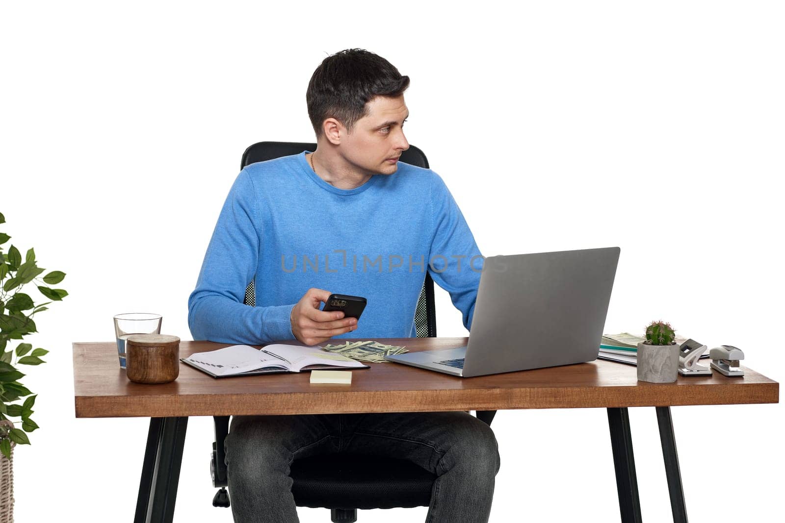 handsome businessman working with laptop and using smartphone on white background
