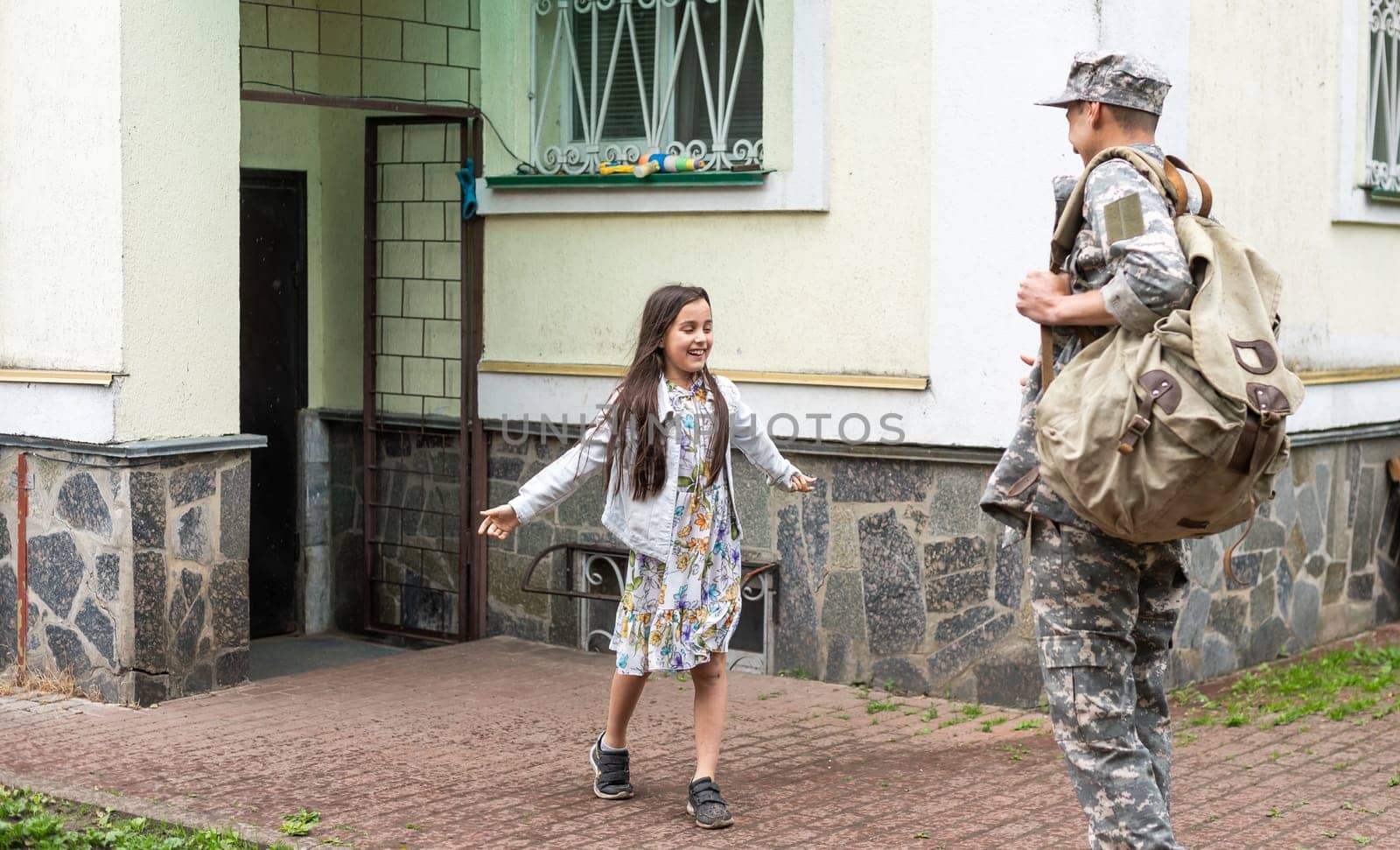 Happy little girl having fun with her military father by Andelov13