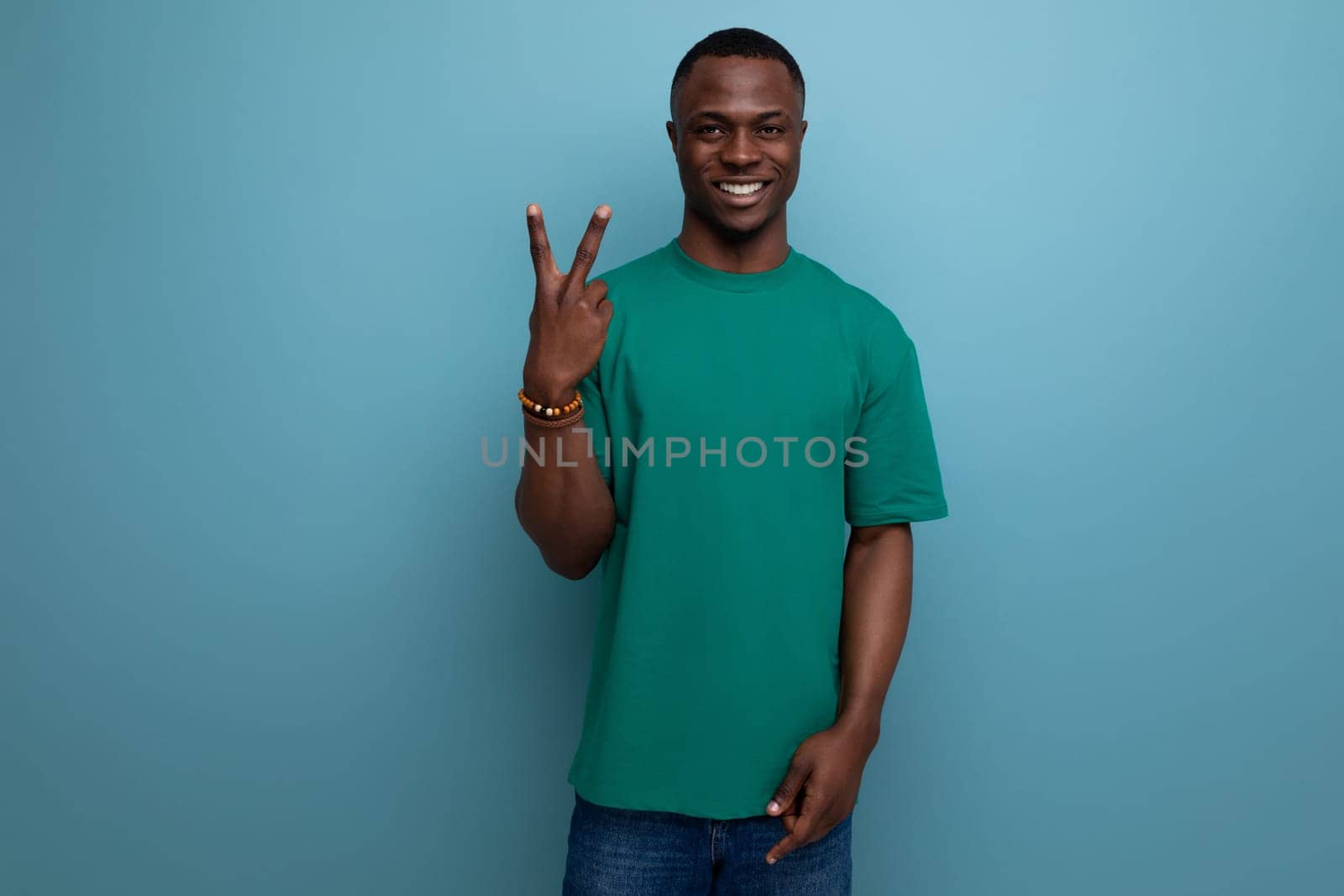 young confident handsome american man in t-shirt on background with copy space.