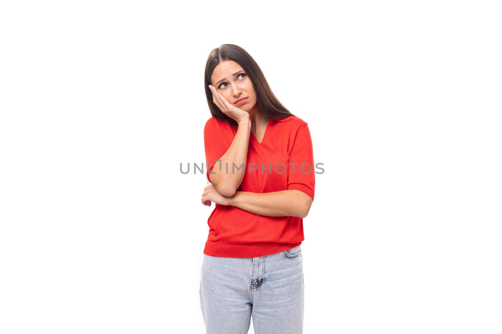 young european woman with black hair dressed in a red t-shirt on a white background with copy space.