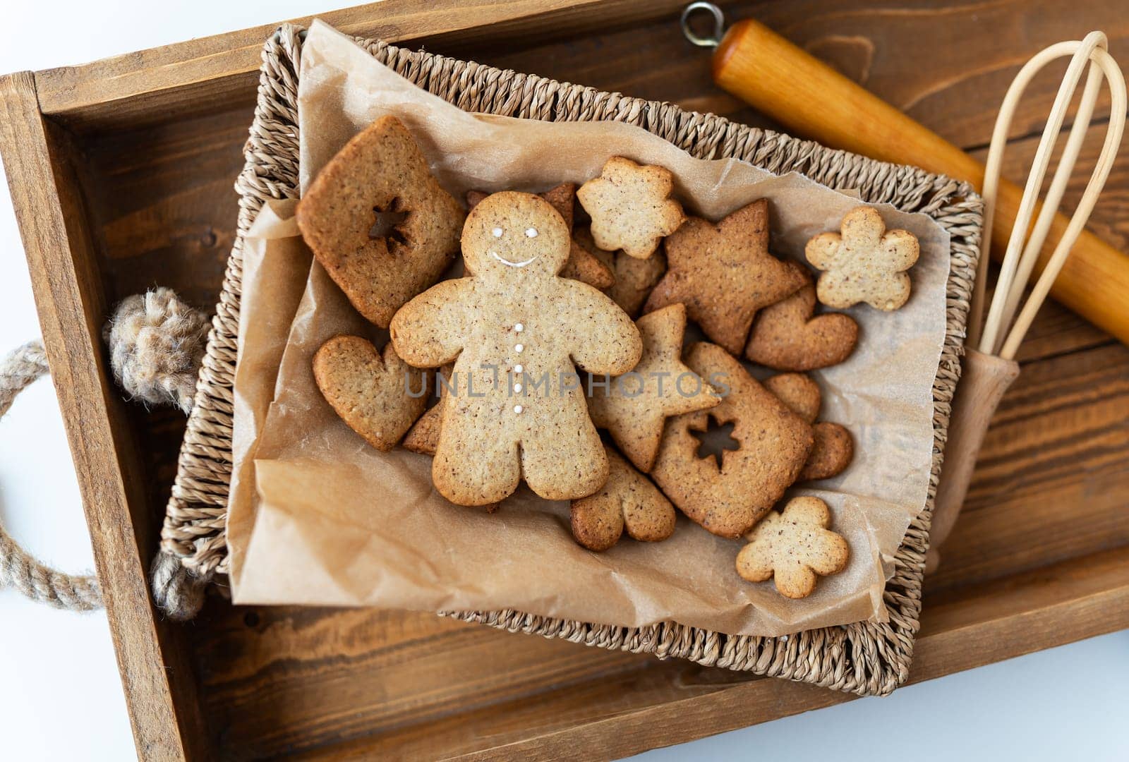 Cooking gingerbread, different gingerbread cookies of different shapes lie on a wooden tray, top view. Holiday concept