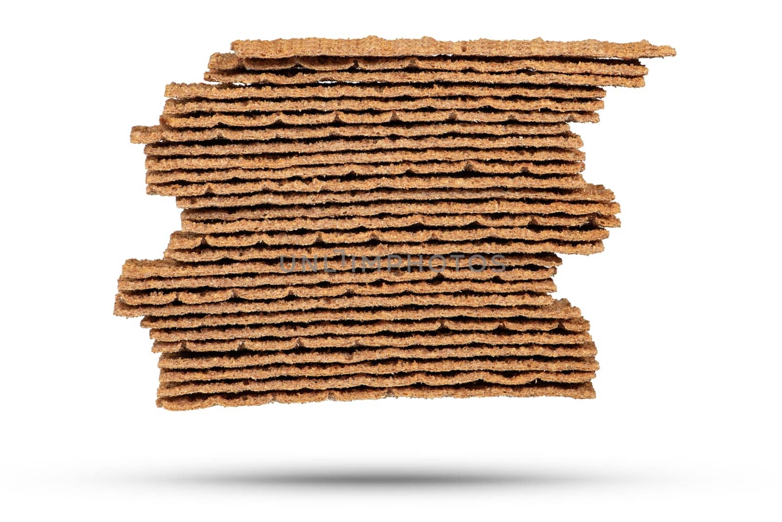 Texture of rye chips on a white background. The chips are stacked one on top of the other, close-up side view. Toasted slices of bread for sandwiches. by SERSOL