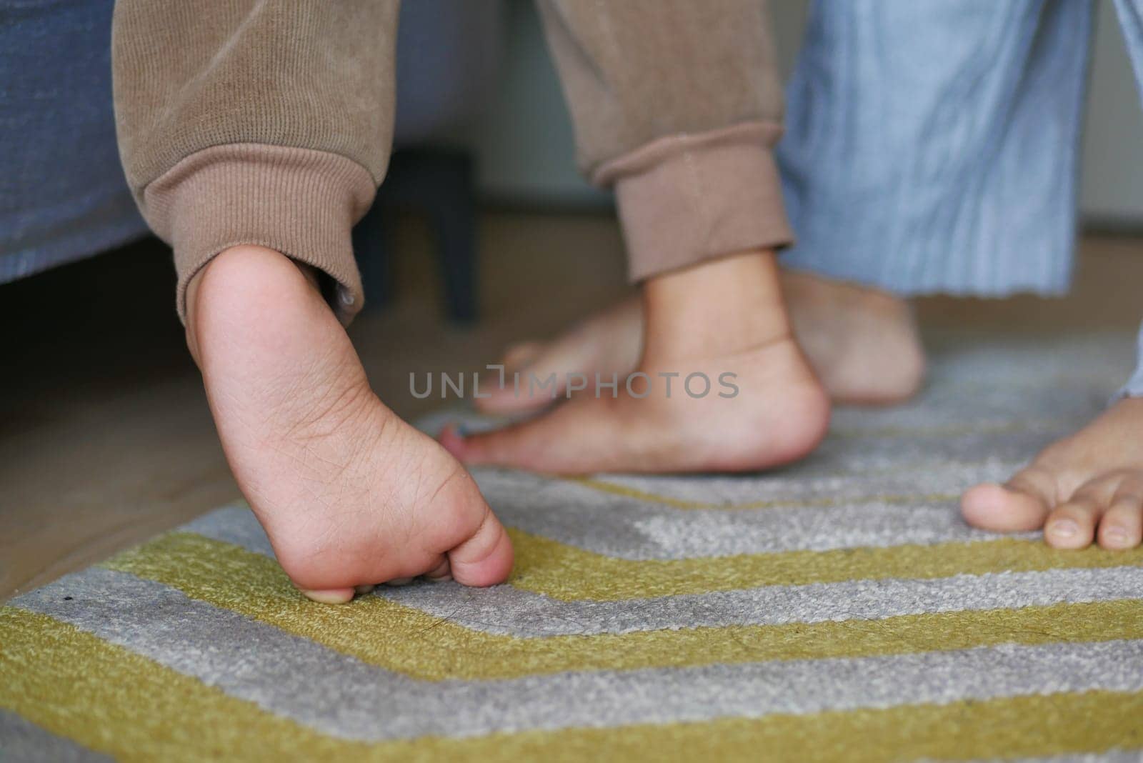 low angle view of A child walking on tiptoes.