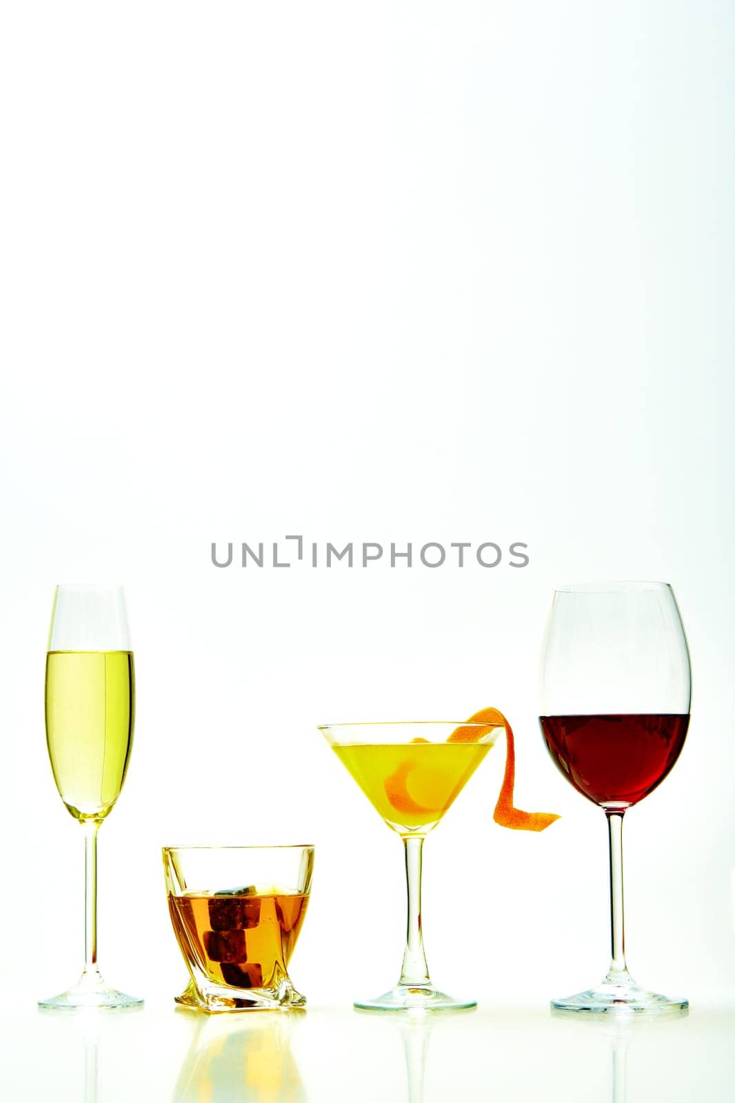 set with different drinks on white background - champagne, whiskey, cocktail, wine