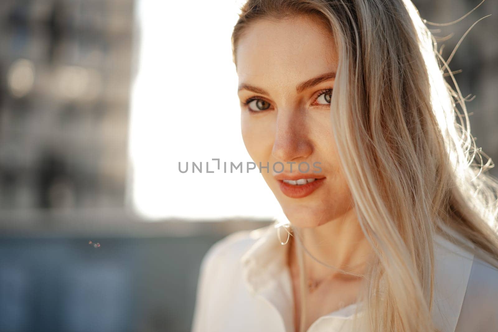 Close up portrait of young blonde businesswoman outdoors