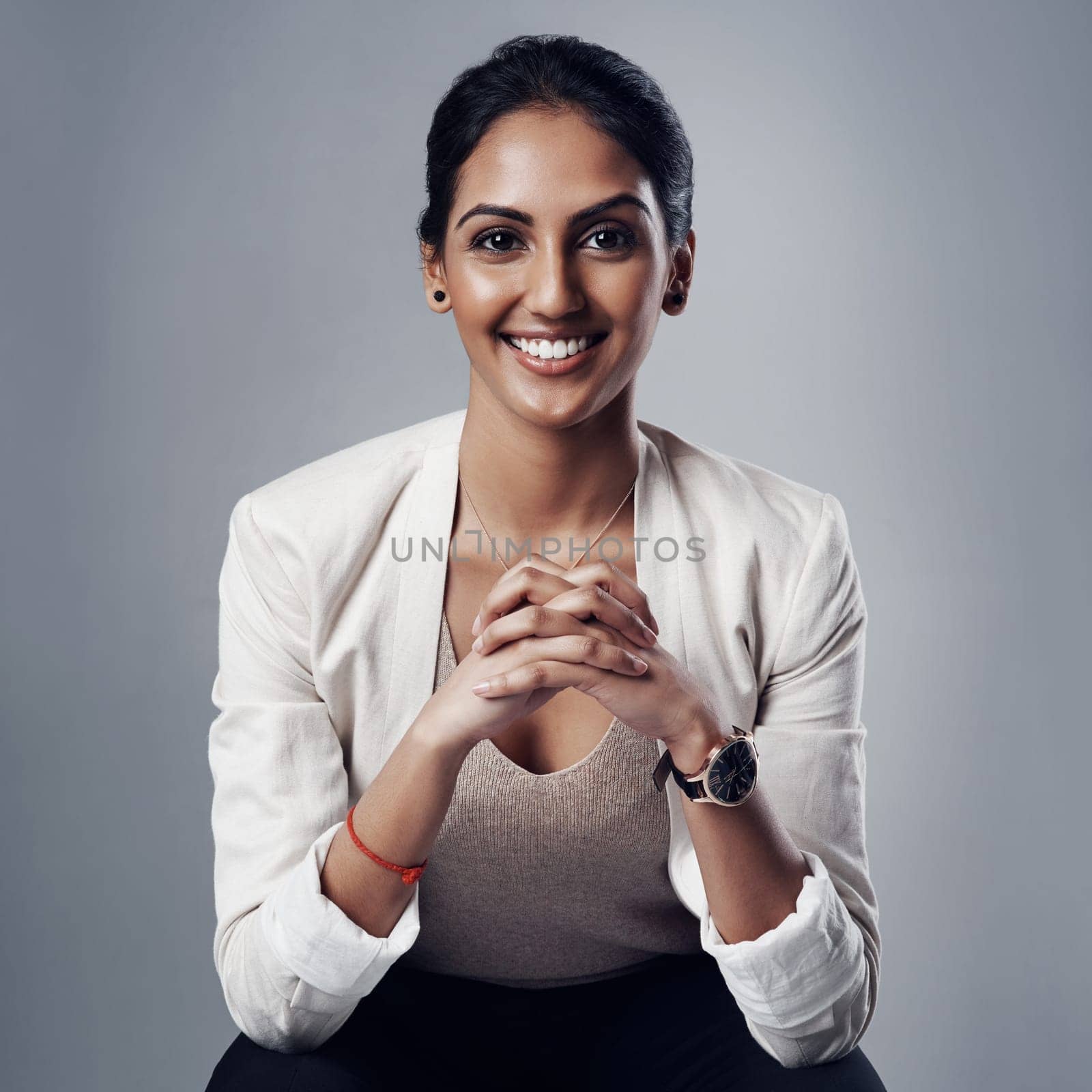 Taking on business with composure, confidence and credibility. Studio portrait of a young businesswoman posing against a gray background