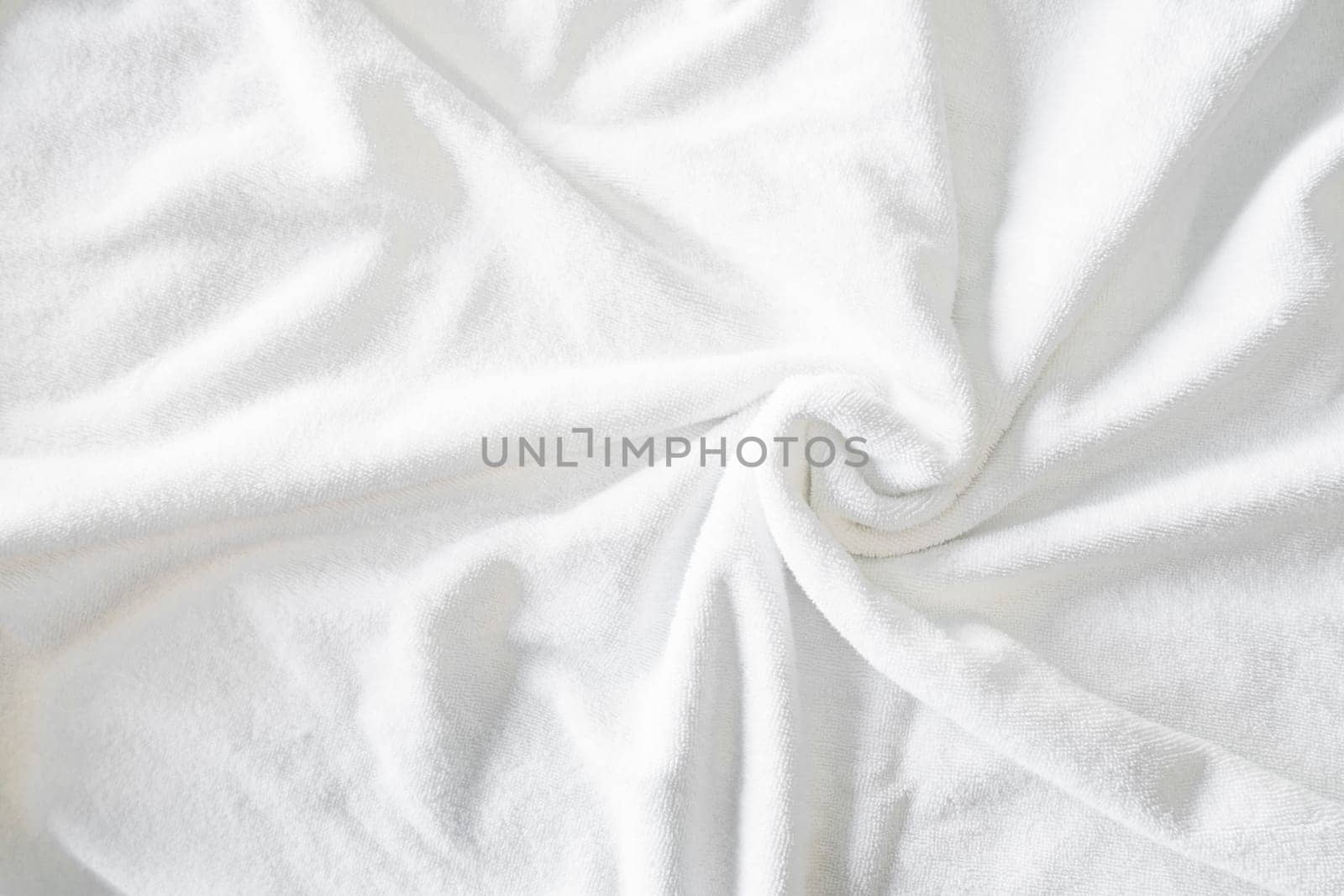 Textured white natural cotton towel background photo with selective focus.