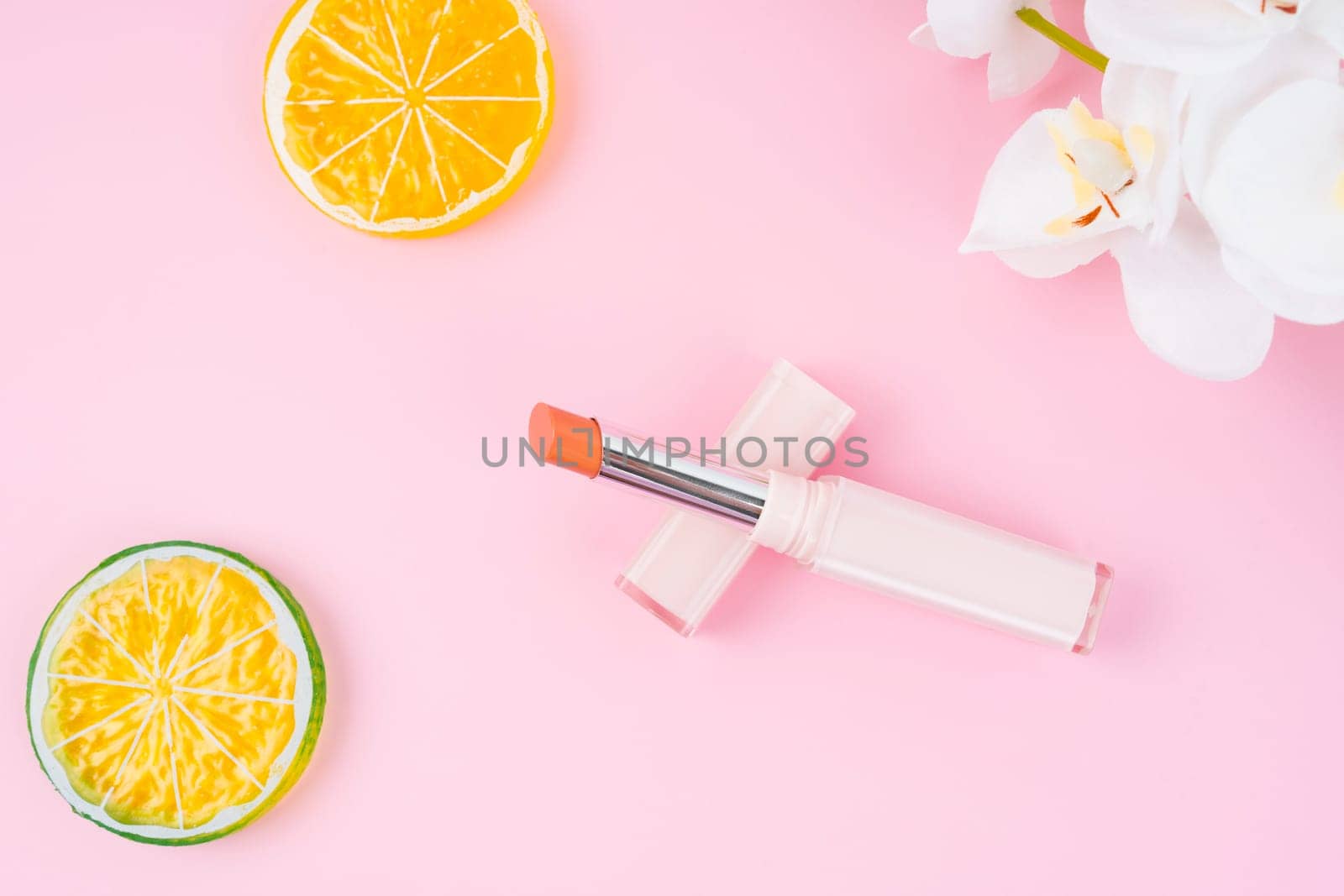 The Red color beautiful lipsticks on pink with decoration background. by Gamjai