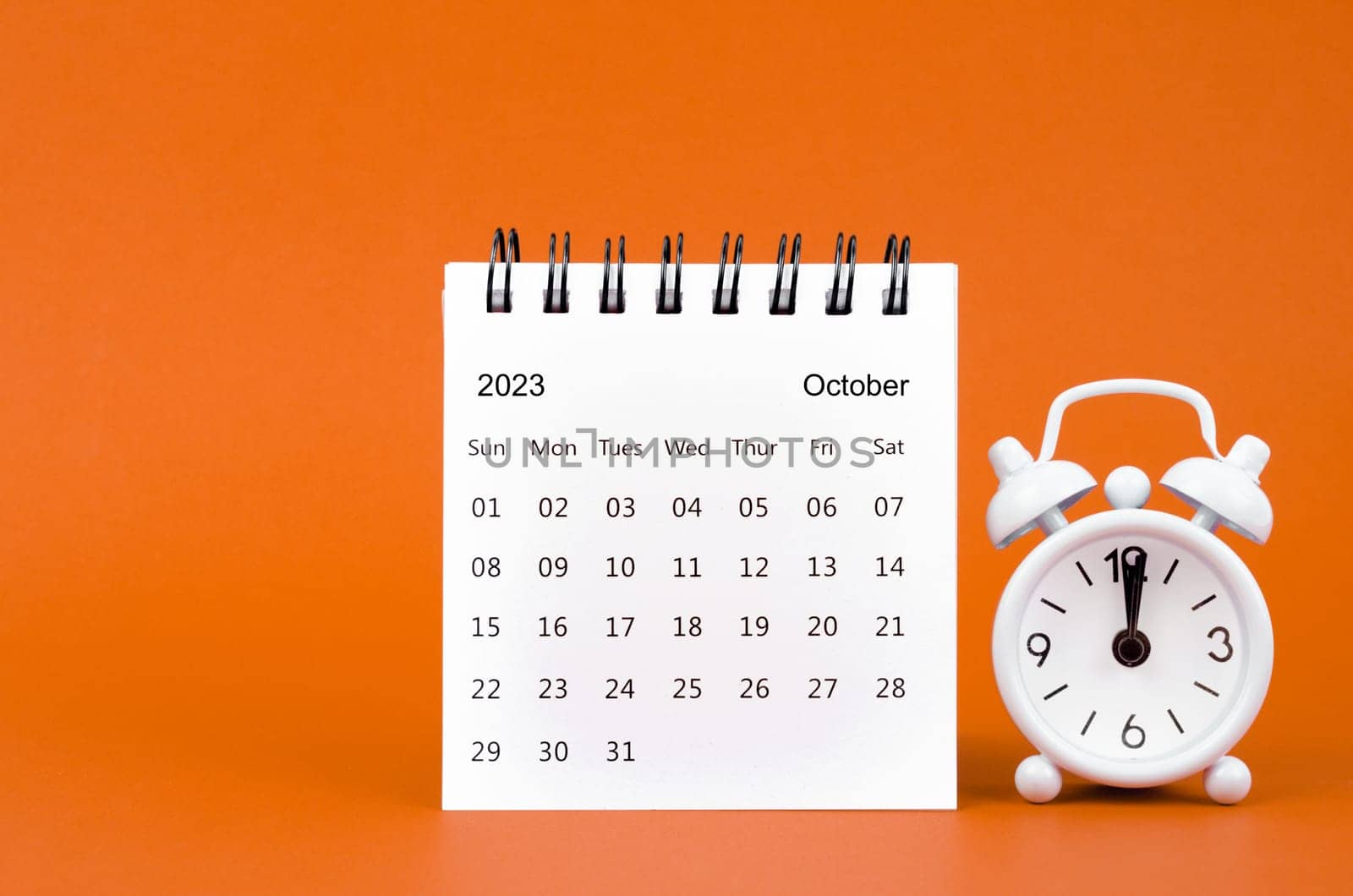 October 2023 Monthly desk calendar for 2023 year and alarm clock