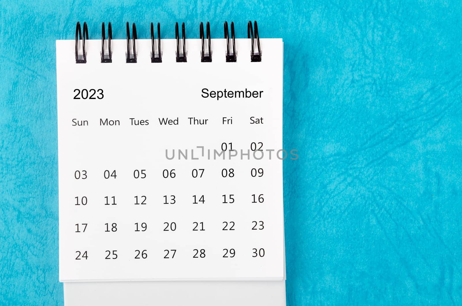 September 2023 Monthly desk calendar for 2023 year on blue background.