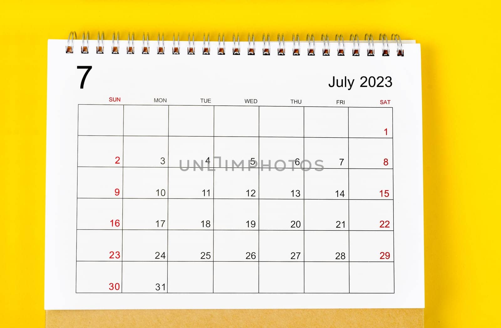 July 2023 Monthly desk calendar for 2023 year on yellow background.