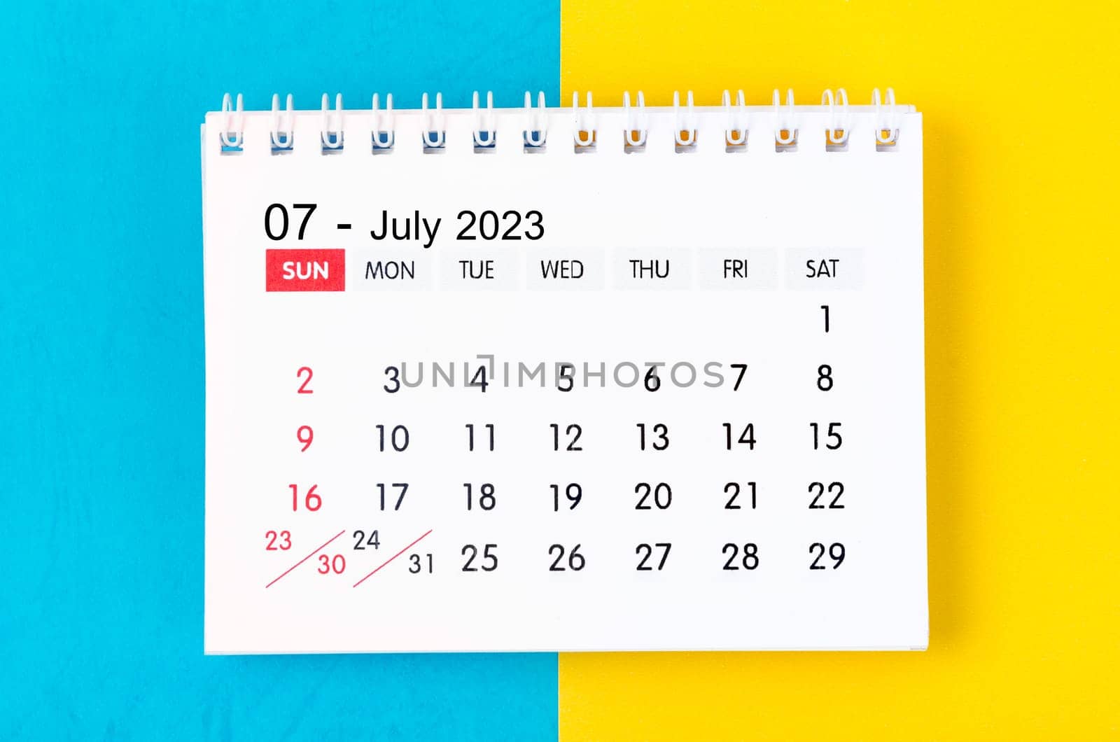 The July 2023 Monthly desk calendar for 2023 year on blue and yellow background. by Gamjai