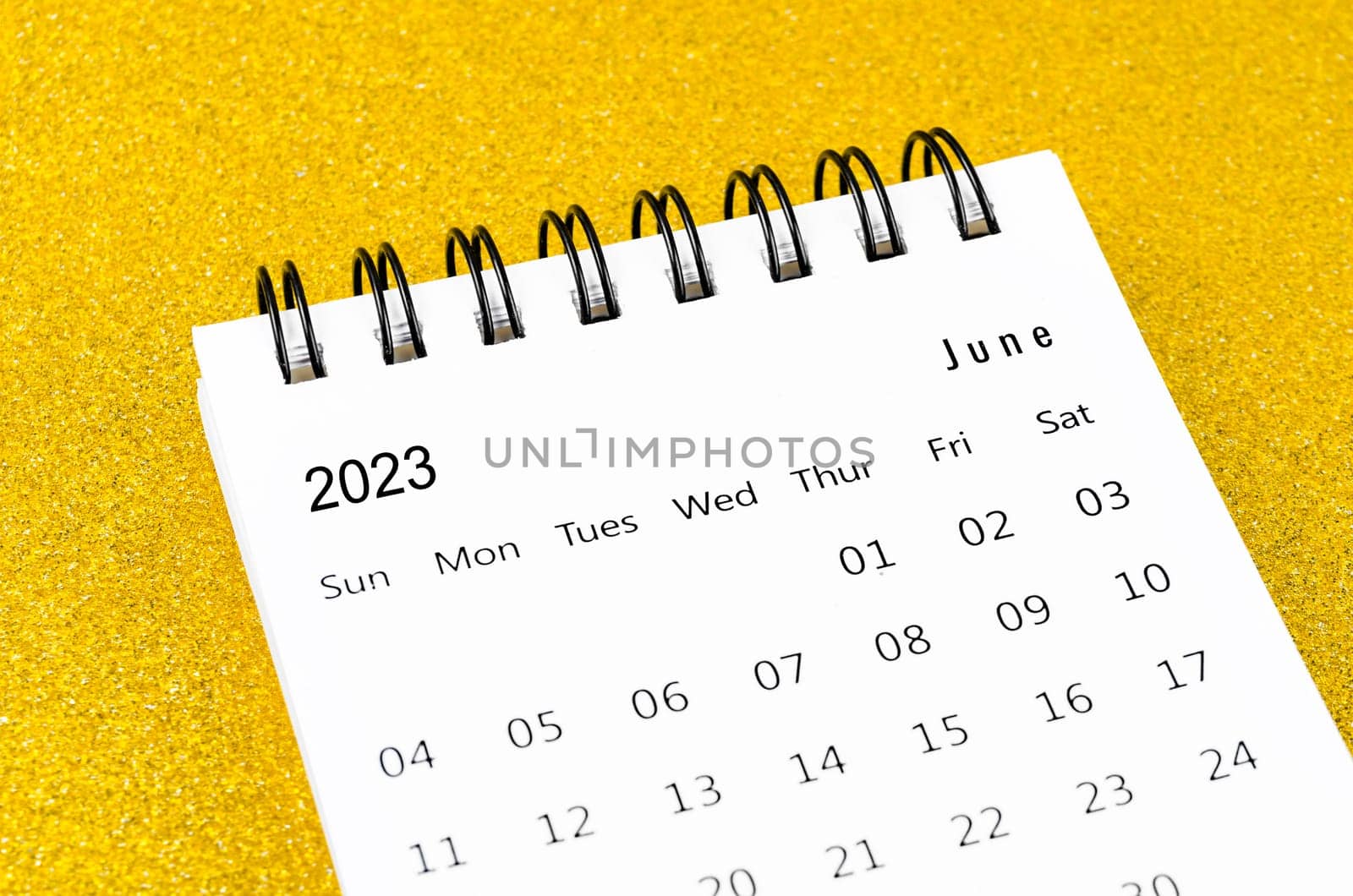 June 2023 Monthly desk calendar for 2023 year on golden color background.