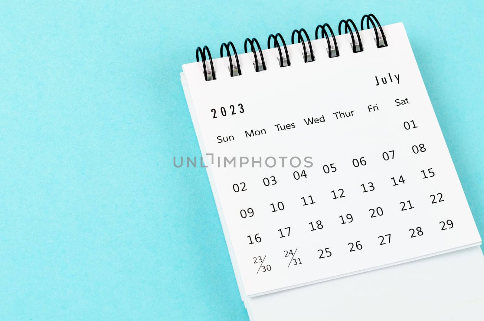 July 2023 Monthly desk calendar for 2023 year on blue background.