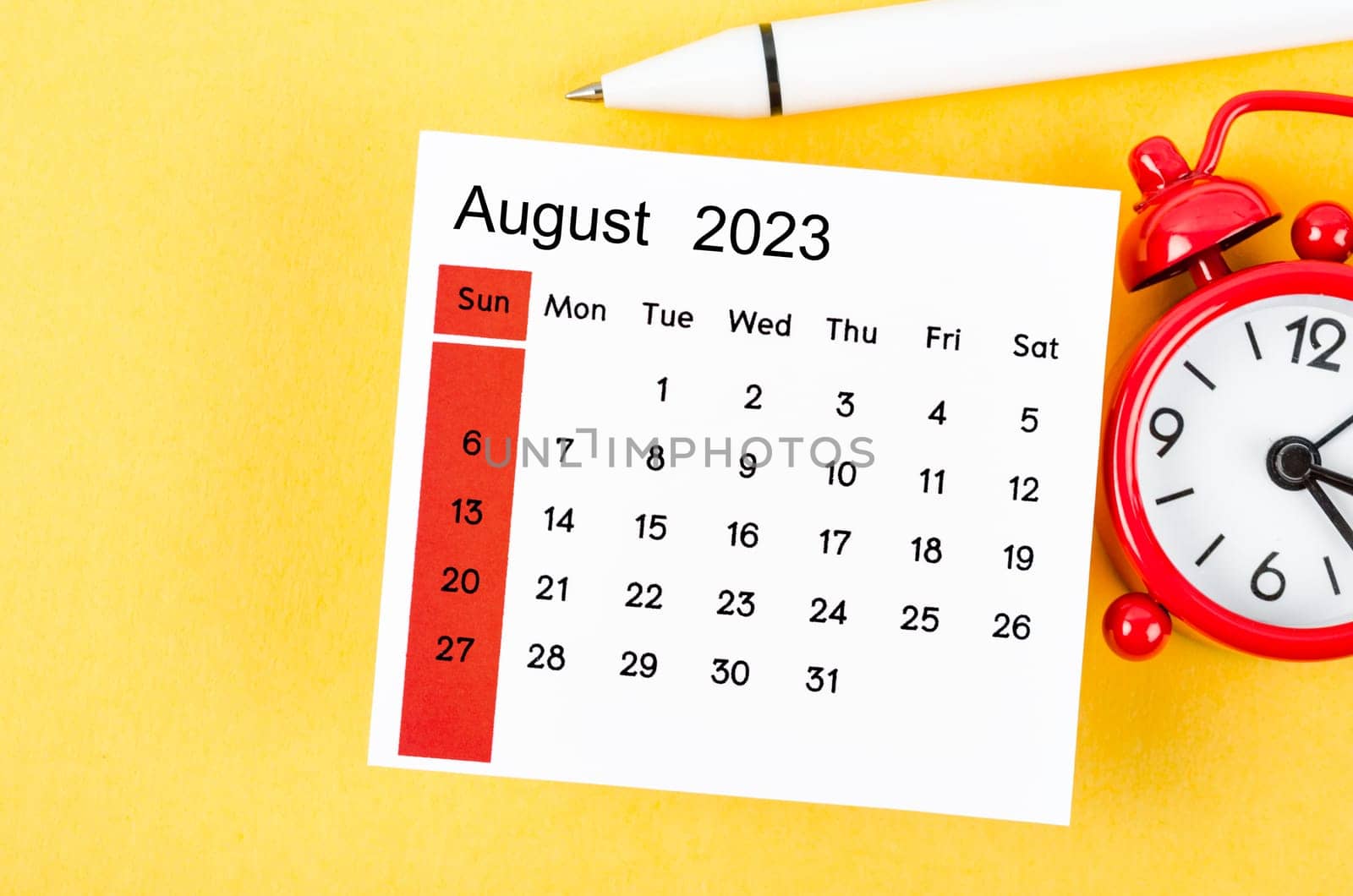 August 2023 Monthly calendar for 2023 year with alarm clock on yellow background.