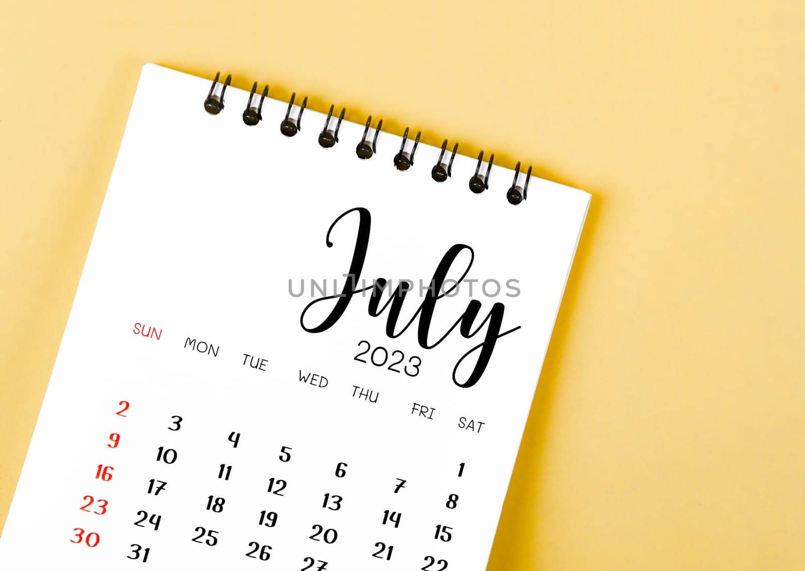 July 2023 Monthly desk calendar for 2023 year on yellow background.