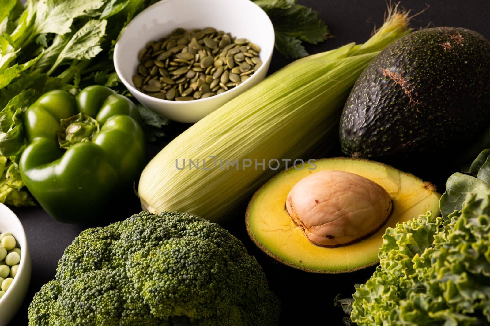 High angle view of various green fruit, vegetables and seeds on table. unaltered, healthy food, vegetable, raw food, variation and organic concept.