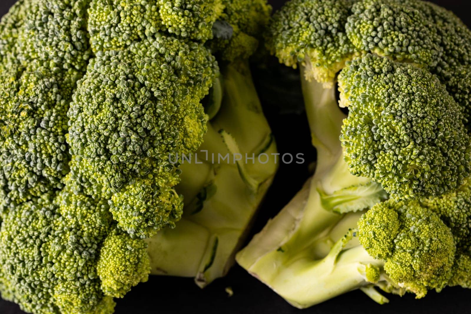 Extreme close-up of fresh green broccolis. unaltered, vegetable, healthy food, raw food and organic concept.