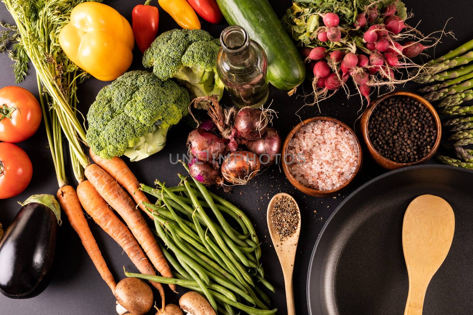 High angle view of various vegetables with spices, herbs, oil and frying pan on table by Wavebreakmedia