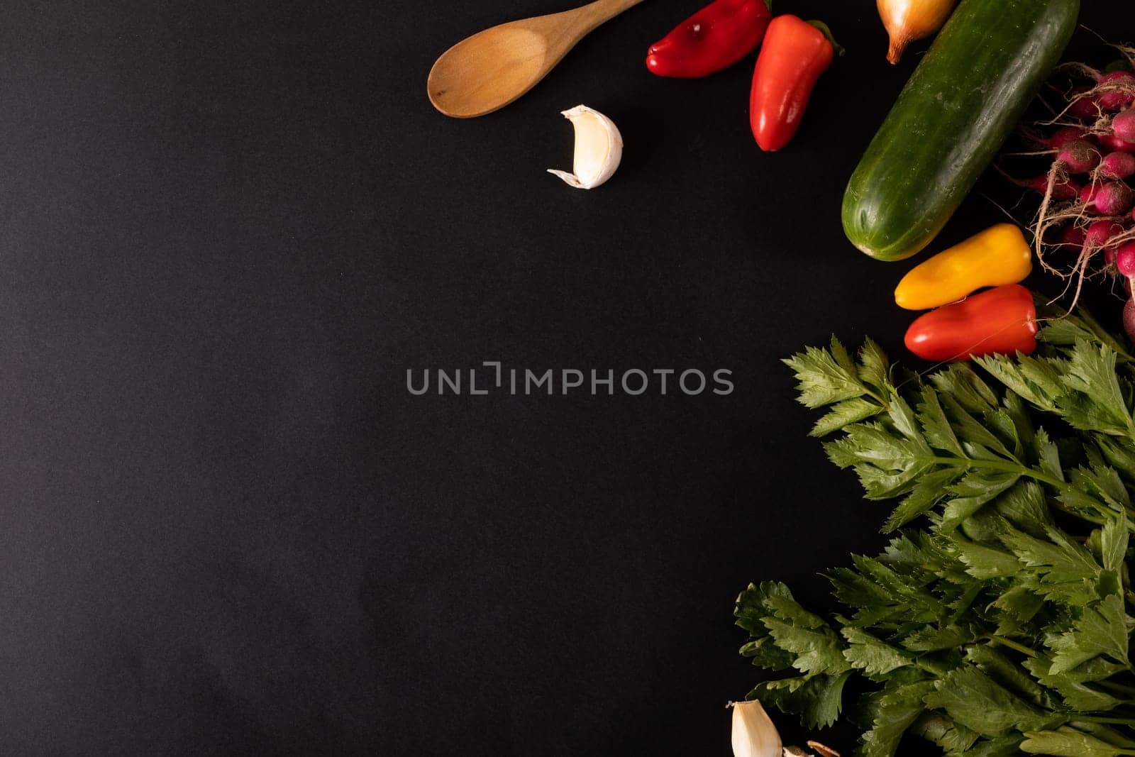 Overhead view of fresh vegetables and ingredients on black background, copy space. unaltered, food, studio shot, healthy eating, organic.