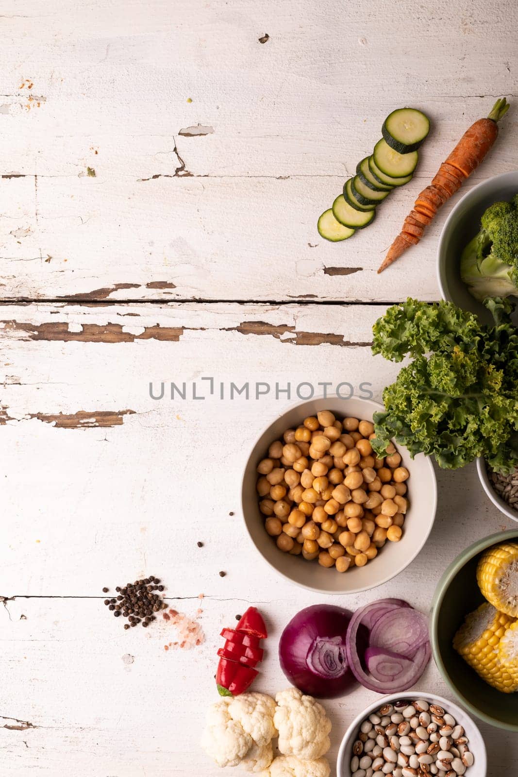 Overhead view of healthy food and ingredients on white table, copy space. unaltered, food, preparation, healthy eating.
