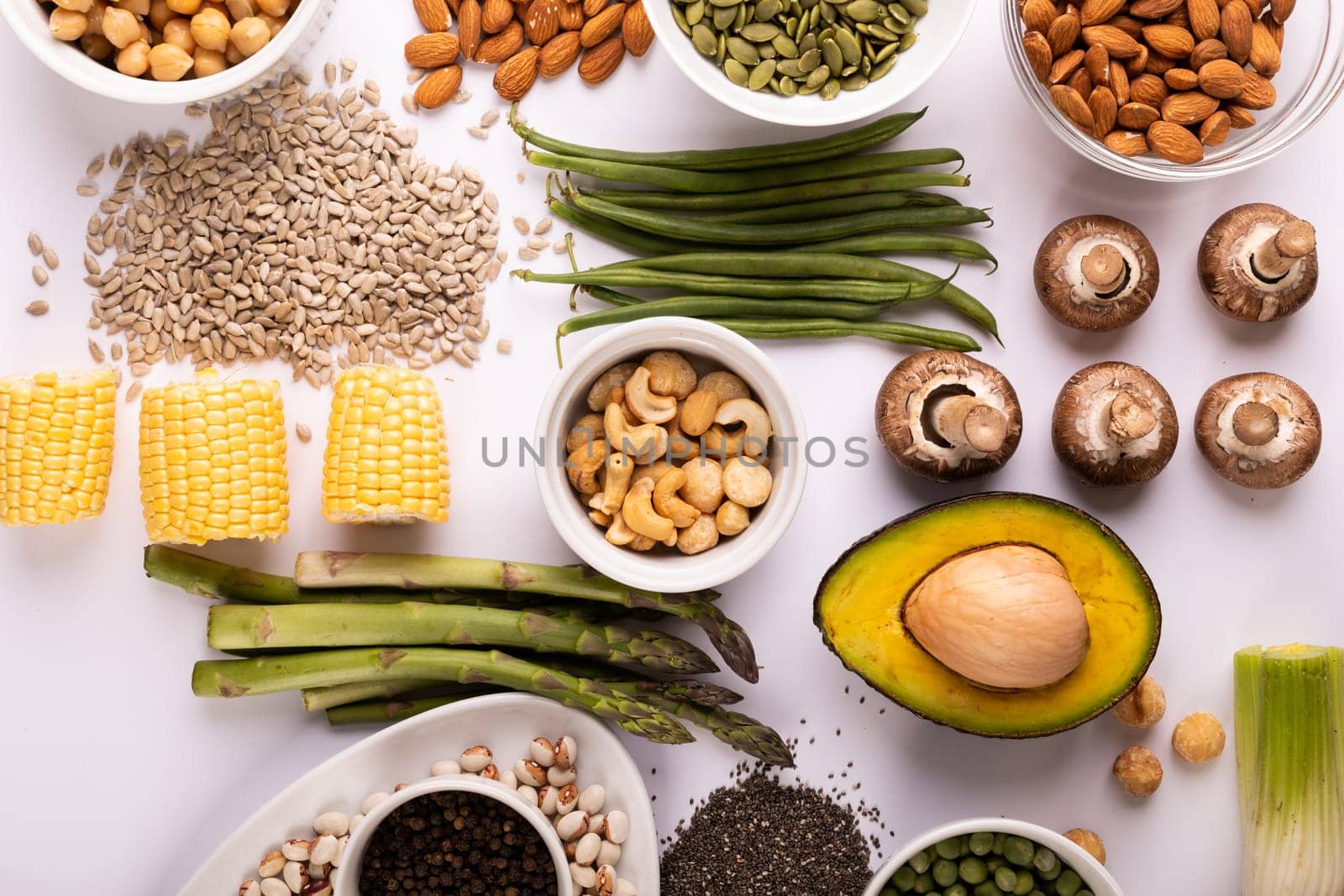 Overhead view of healthy food and ingredients arranged on white table, copy space by Wavebreakmedia