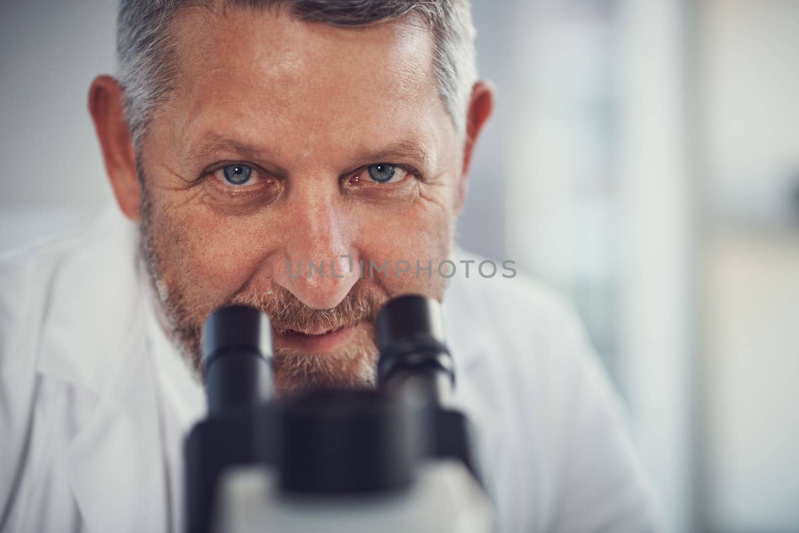 Nothing escapes my eye. Portrait of a mature scientist using a microscope in a laboratory