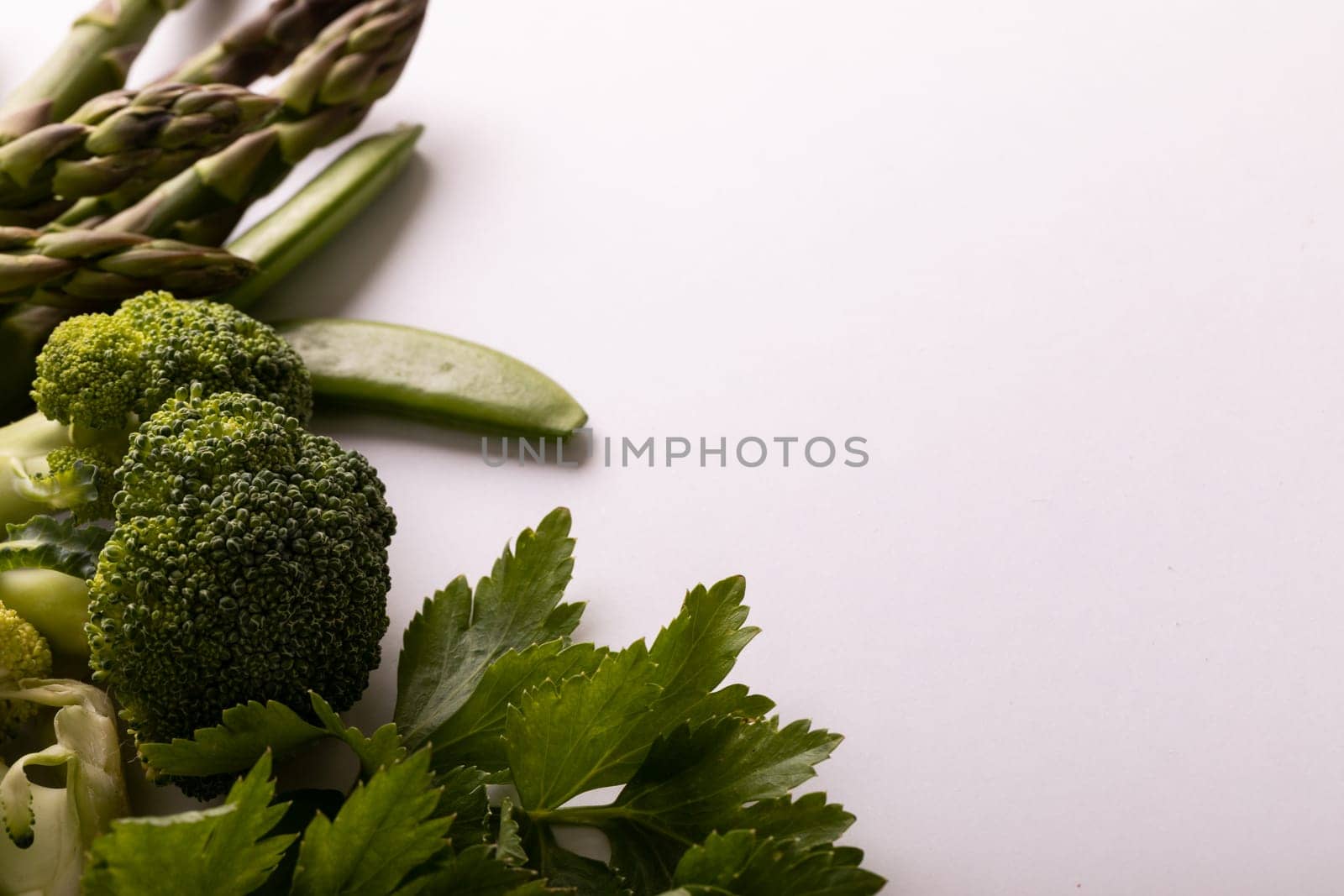 Close-up of various green vegetables on white background, copy space by Wavebreakmedia