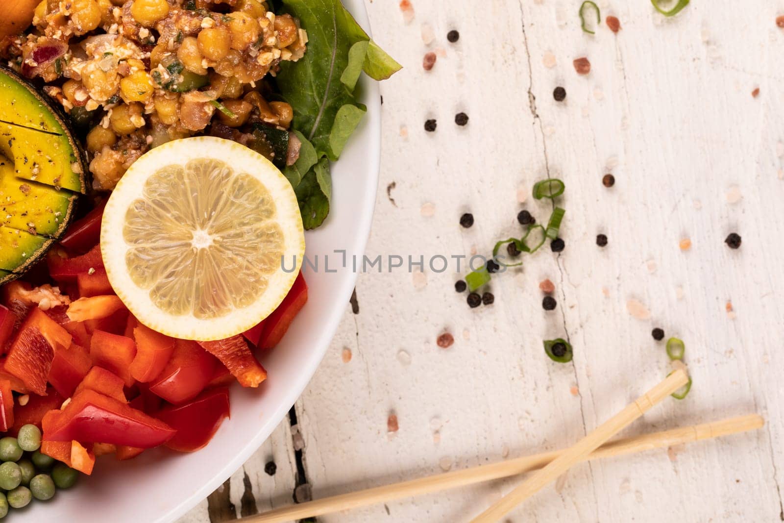Directly above view of fresh meal served in bowl by peppercorn on white background by Wavebreakmedia