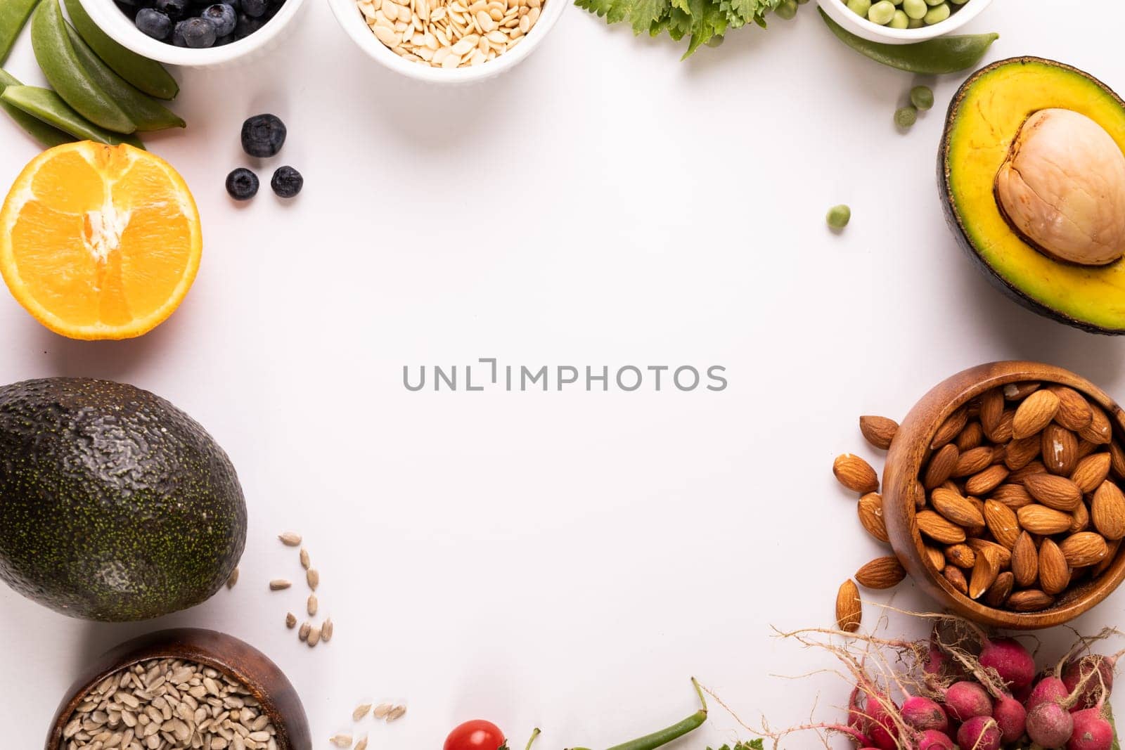 Overhead view of copy space surrounded by various fresh food on white background. unaltered, food, healthy eating, organic concept.