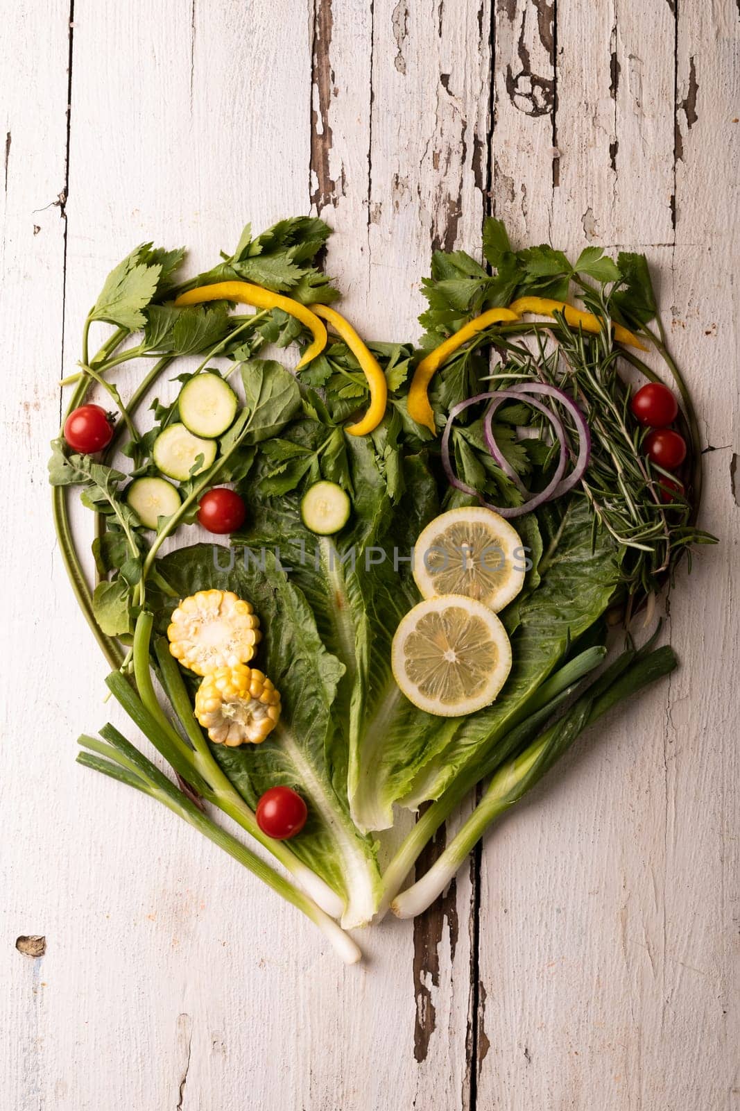 Directly above view of fresh green vegetables arranged as heart shape on white wooden table. unaltered, food, healthy eating, organic concept.